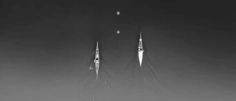 Two rowers in separate boats paddle side by side on calm water, as seen from above—mirroring the synchronization and strategy needed in enterprise or AI-driven SEO teams.